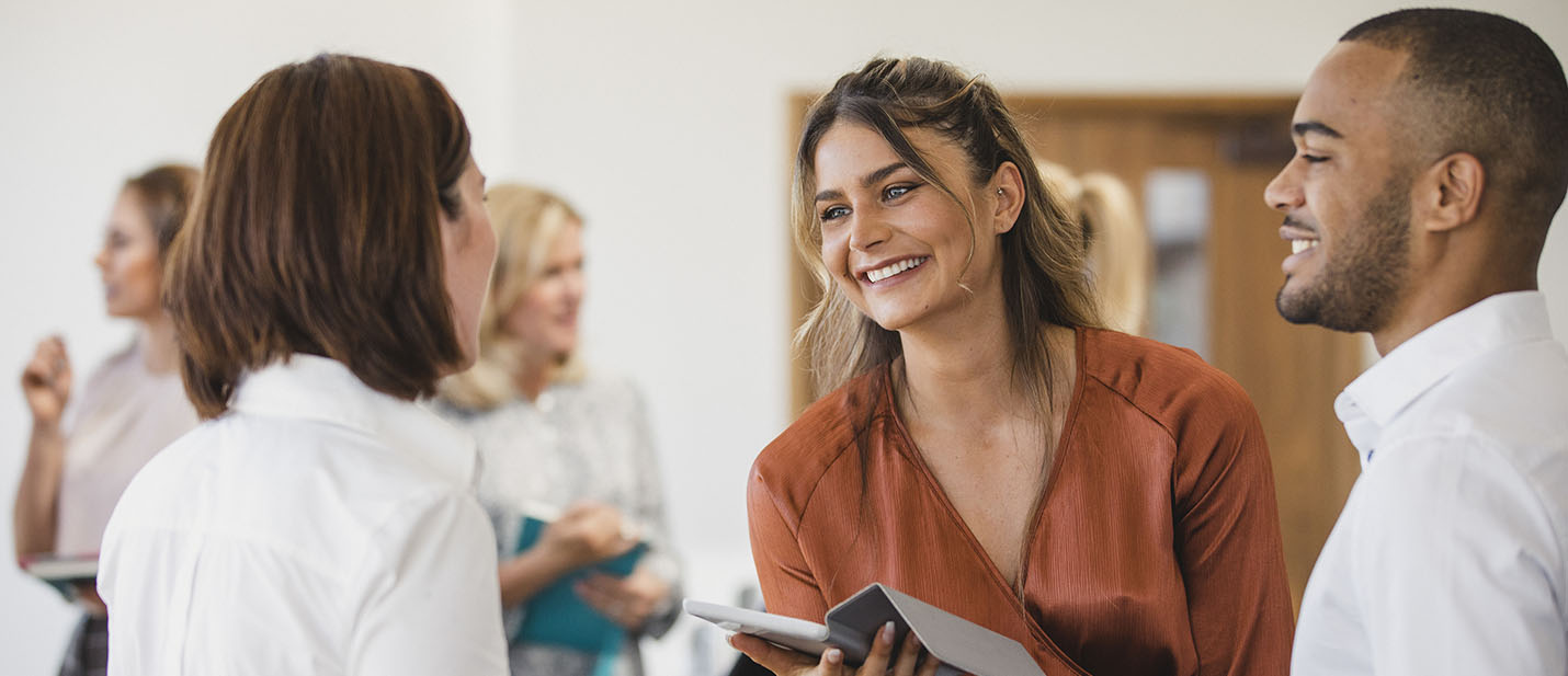 Young businesswoman smiling and listening, networking, collaboration, business conference